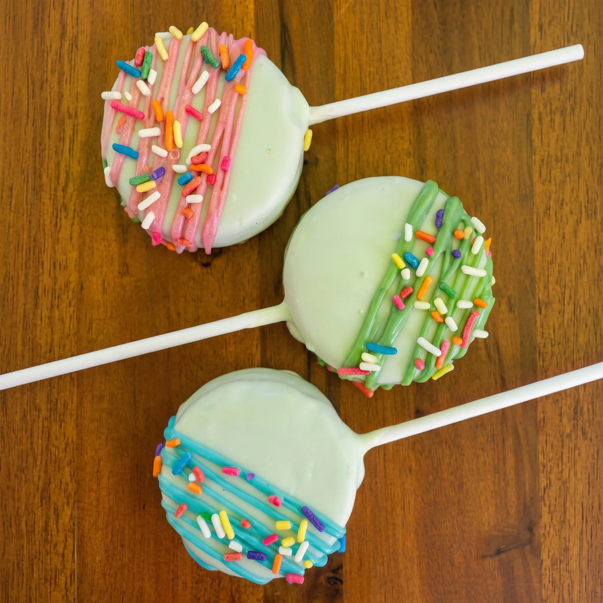 Three colorful decorated cake pops